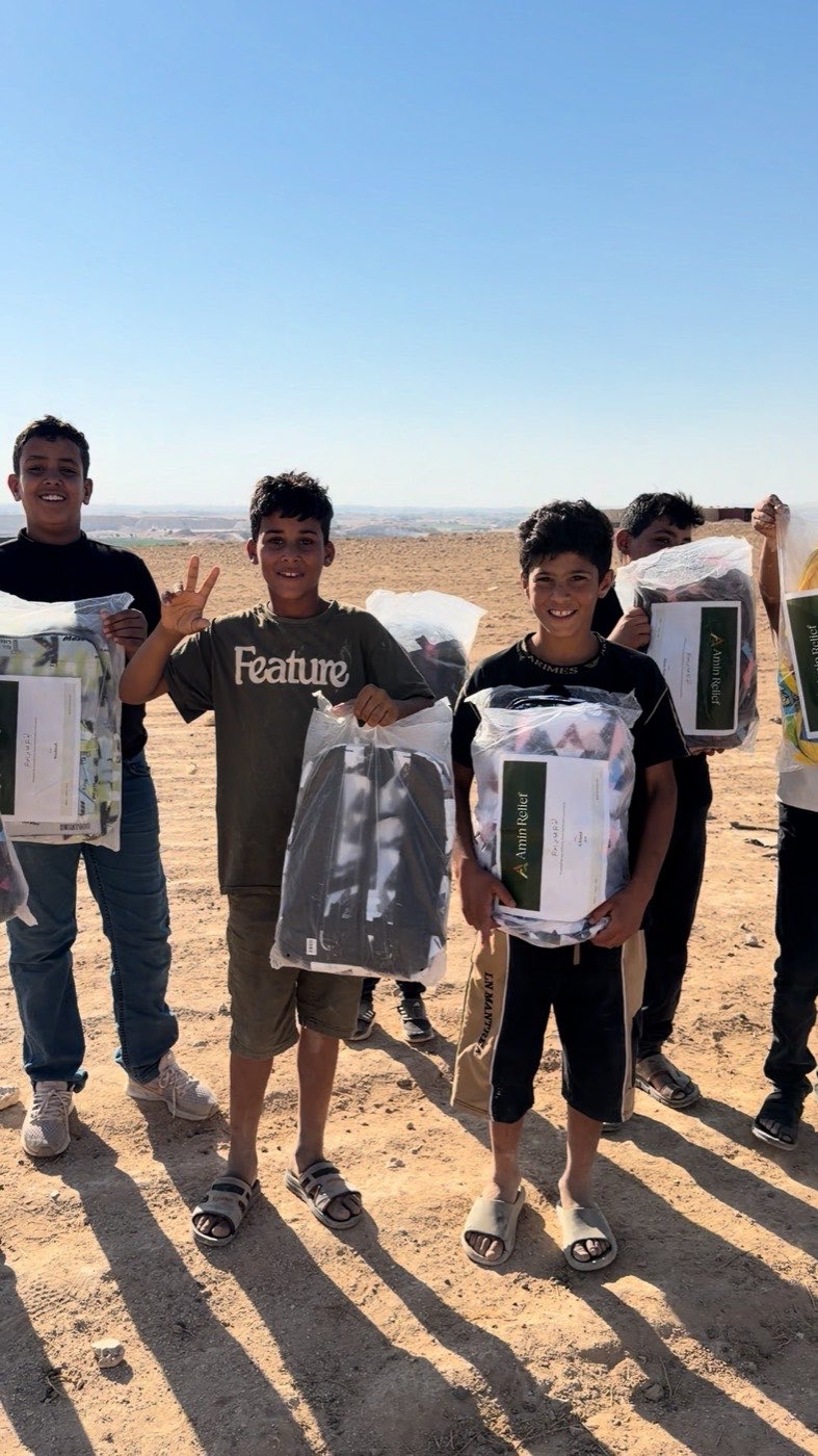 Children holding the stickered packages they have just been handed